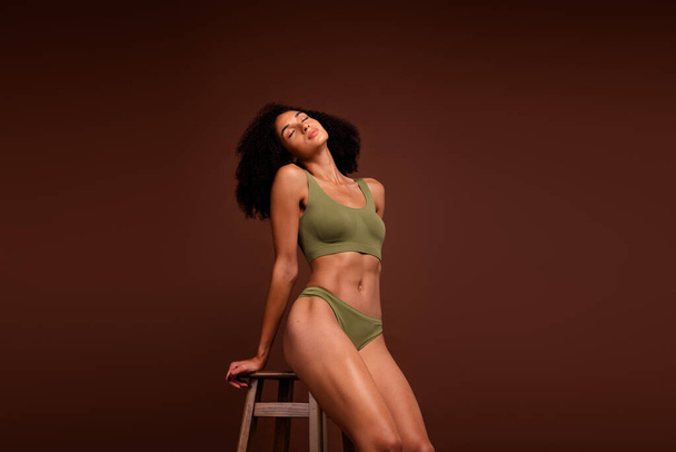No retouch photo of gorgeous sporty girl strong muscular forms new fashion khaki lingerie isolated on brown color background. - Φωτογραφία, εικόνα