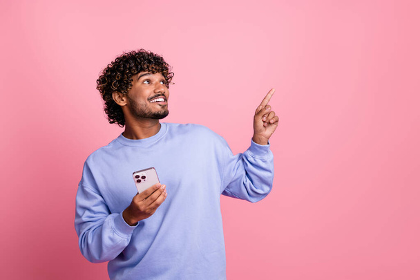 Photo portrait of handsome young male point look empty space promo dressed stylish blue garment isolated on pink color background. - Foto, immagini