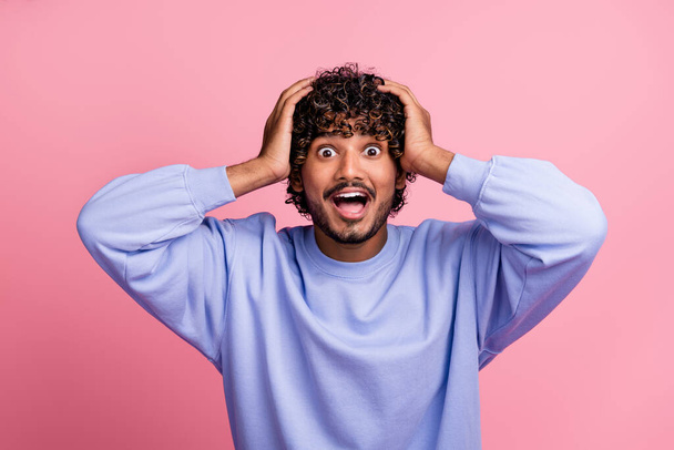 Photo of overjoyed cheerful positive guy wear blue stylish clothes arms touch head scream wow omg isolated on pink color background. - Фото, изображение