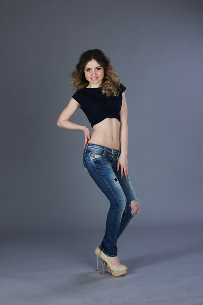 Girl in torn jeans - Фото, изображение