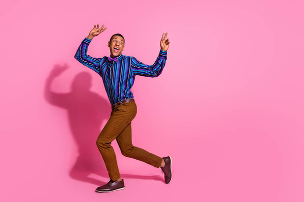 Full length photo of positive funky guy wear striped shirt dancing disco empty space isolated pink color background. - Fotoğraf, Görsel