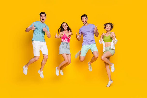 Full body photo of funky cheerful people jumping showing fine symbol isolated shine color background. - Fotografie, Obrázek