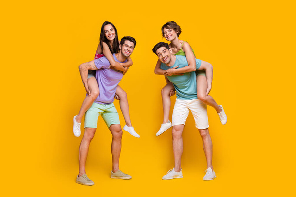 Full length photo of people rest relax guys piggyback girls isolated shine color background. - Foto, Imagen