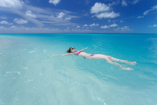 Woman floating on a back in the beautiful sea - Foto, Imagen
