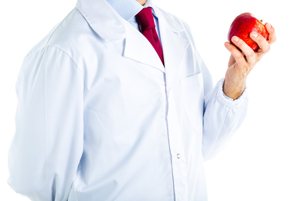 Doctor in white coat showing a red apple - Foto, Imagen