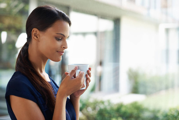 Woman, thinking and drinking coffee in home to relax, peace or calm at breakfast for energy in the morning. Dream, tea cup or person with espresso, latte or hot healthy beverage for wellness in house. - Photo, Image