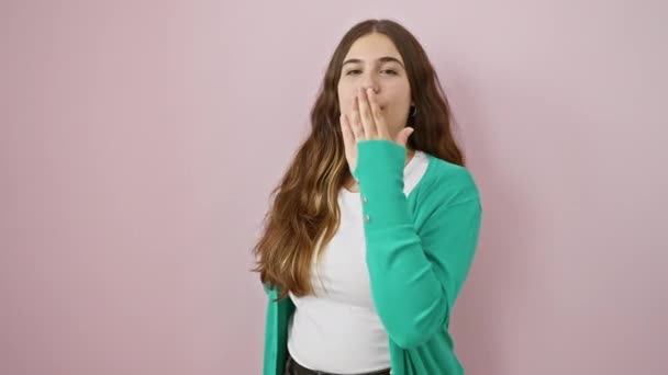 Young, beautiful hispanic woman blows air kiss, expressing love. full of positive energy, she stands sexy and lovely over isolated pink background. - Footage, Video