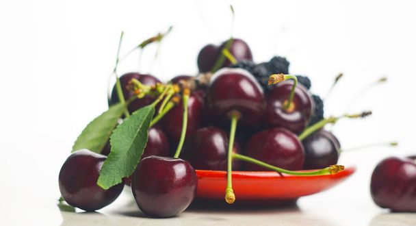                                   There are red cherries on a white background   - Photo, Image