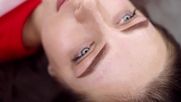 The completed work of permanent eyebrow makeup, the girl poses in front of the camera. Permanent makeup procedure, performing PMU of eyebrows - Footage, Video