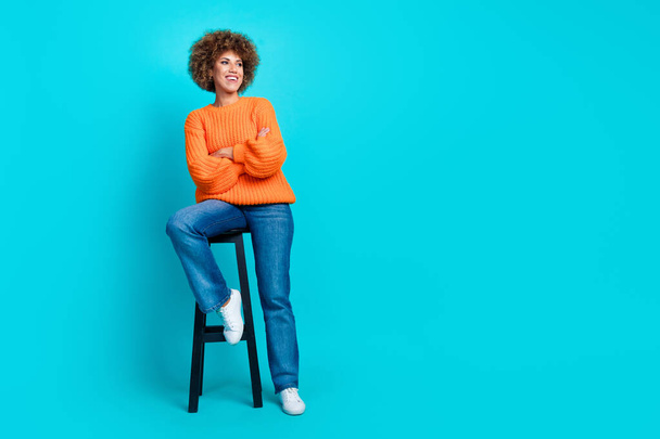 Full length portrait of charming nice person sit chair crossed hands look empty space isolated on turquoise color background. - Valokuva, kuva