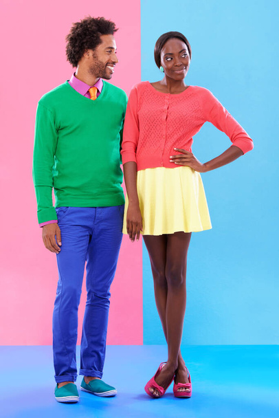Fashion, happy and young black couple in studio with colorful, trendy and stylish outfit. Smile, love and full body of confident African man and woman with edgy, classy and retro style by background - Photo, Image
