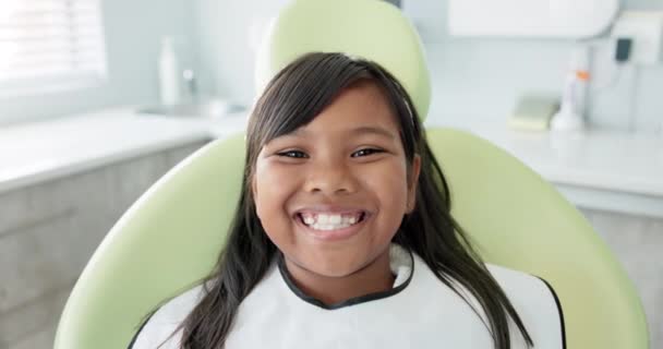 Dental, smile and face of girl at a dentist for teeth whitening, consultation or growth check. Oral care, portrait and happy kid in dentistry office for mouth, gum or consulting specialist for braces. - Footage, Video