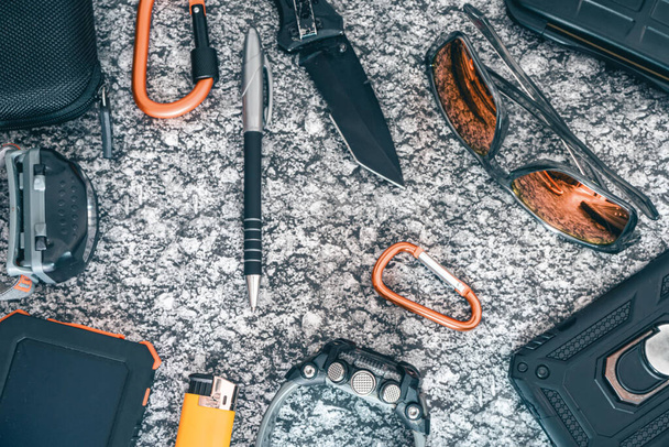 Flat lay of some Outdoor/EDC gear on a grey background. - Photo, Image