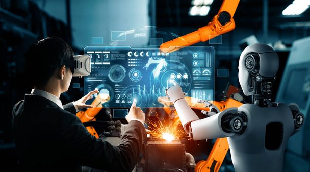 XAI Mechanized industry robot and human worker working together in future factory. Concept of artificial intelligence for industrial revolution and automation manufacturing process. - Photo, Image