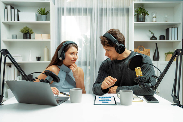 Host channel broadcasters discussing together, making advice for problem in live streaming with listeners surrounded sets of live streaming on radio talking show at comfy modern workplace. Postulate. - Photo, Image