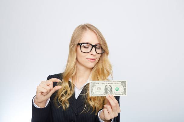 Attractive business woman.  Holding a one dollar and euro. - 写真・画像