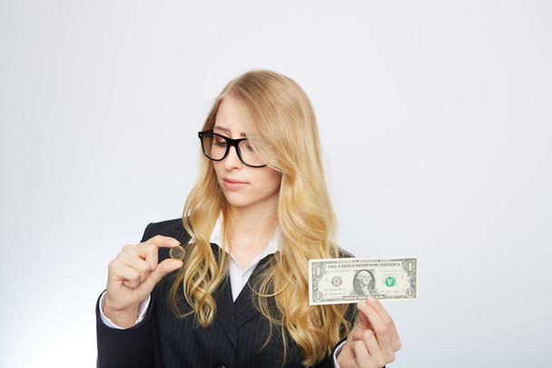 Attractive business woman.  Holding a one dollar and euro. - Photo, Image