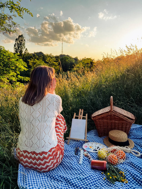 Painters paradise: woman creates art during picnic. - Photo, Image