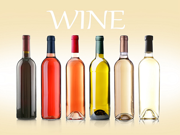 Wine bottles in row on light background - Zdjęcie, obraz