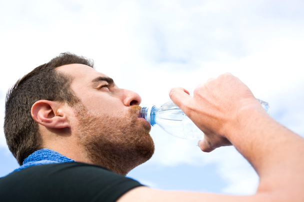 Man drinking water after exercise practice - Photo, Image