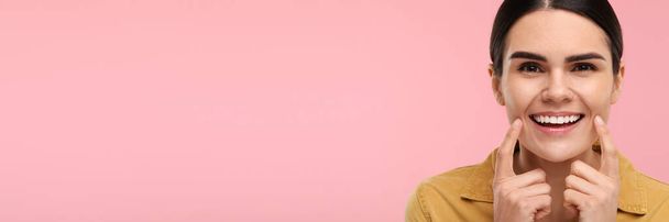Woman with clean teeth smiling on pink background, space for text. Banner design - Foto, Imagem