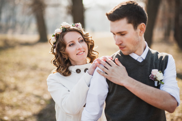 bride and groom standing together in spring park - Fotografie, Obrázek