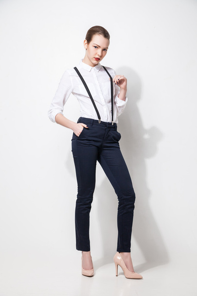 fashion model in black trousers and top posing over white - Фото, зображення