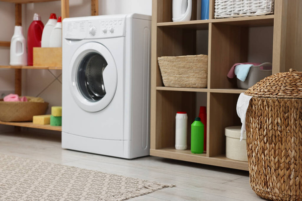 Laundry room interior with washing machine and furniture - Фото, изображение