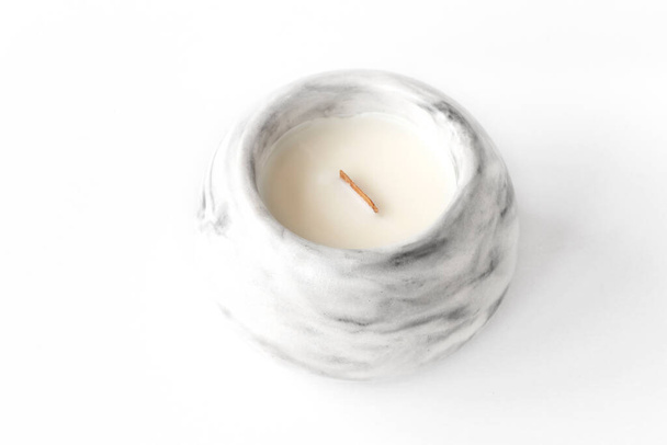 scented candle with a wooden wick in a plaster candlestick, close-up on a white background - Photo, Image