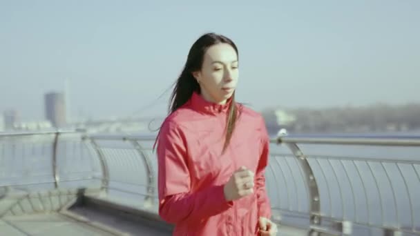 mladá žena jogging na břehu řeky  - Záběry, video