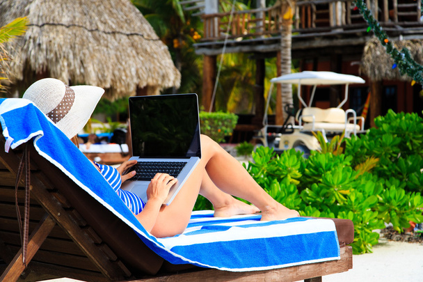 woman with laptop on tropical beach - Photo, Image