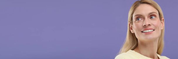 Woman with clean teeth smiling on violet background, space for text. Banner design - Foto, Imagem