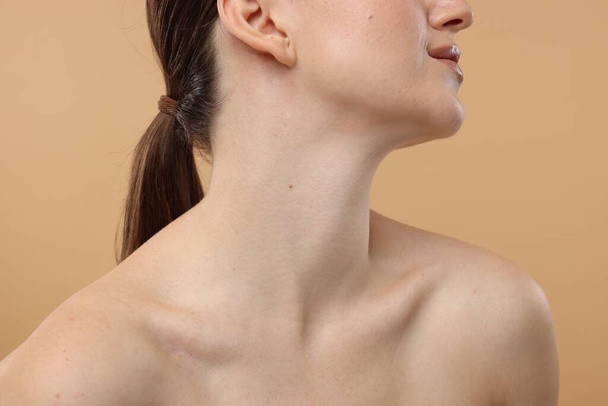 Beauty concept. Woman on beige background, closeup - Photo, Image