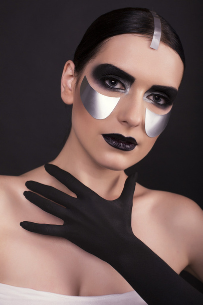 woman with dark  hair and metallic extraordinary makeup     - Foto, Imagem