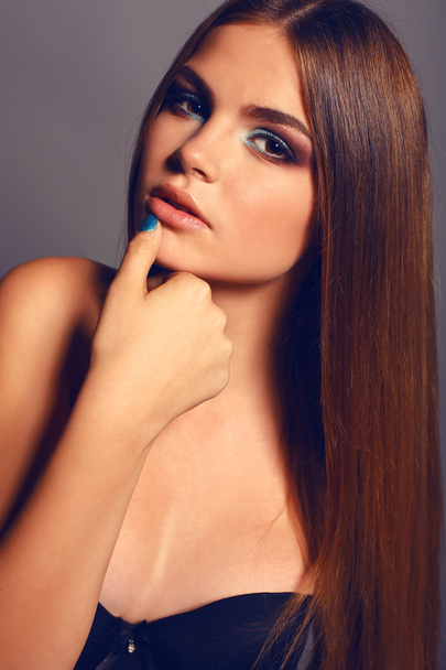 young woman with straight dark hair and bright makeup   - Foto, Imagen