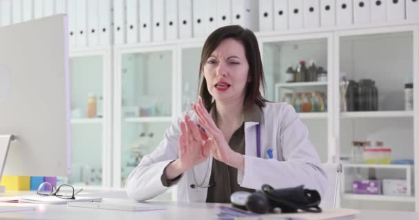 Nainen lääkäri osoittaa negatiivista elettä klinikan vastaanotossa 4k elokuva hidastettuna. Noudata tiukasti lääkärin suositusten käsitettä - Materiaali, video