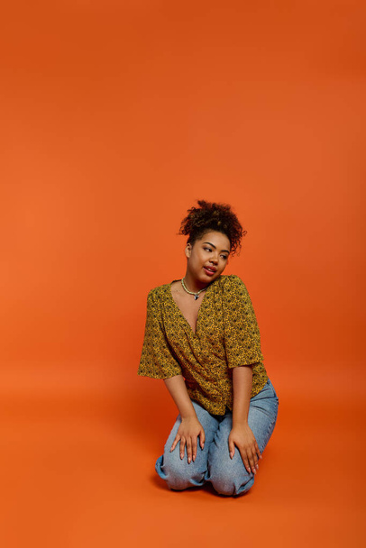 Stylish African American woman amidst vibrant orange backdrop. - Photo, Image