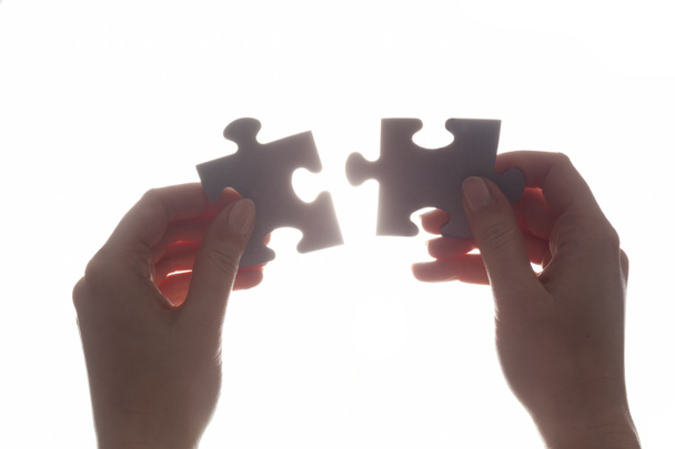 Joining two pieces of jigsaw puzzle. - Photo, Image