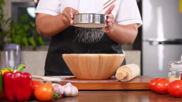 Portrait of obese woman cooking pizza in the kitchen, Raw pizza in the hands of a housewife. Homemade pizza cooking in the kitchen at home. Learning how to make yummy pizza dinner lunch - Filmati, video