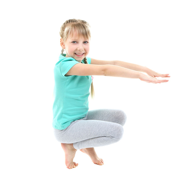 Little girl doing exercises - Foto, afbeelding