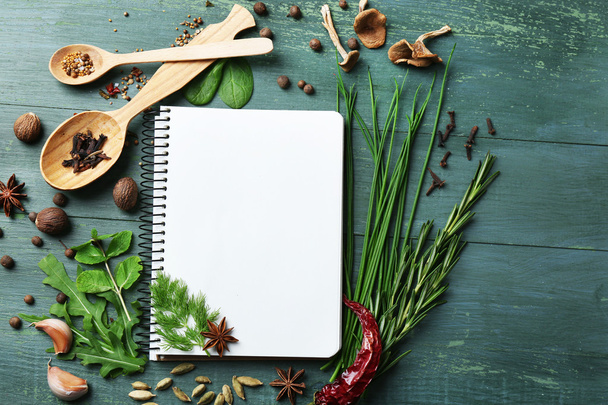 Open recipe book with fresh herbs - Фото, зображення