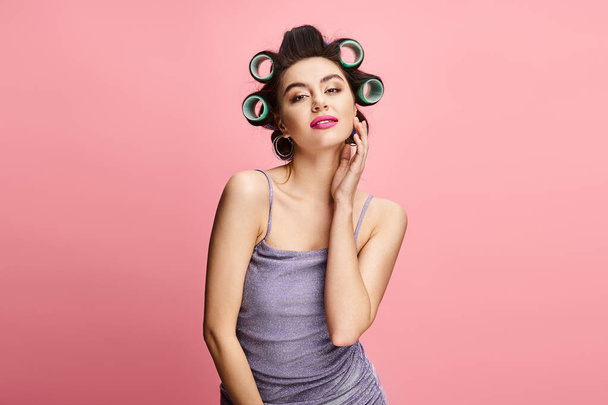 Stylish woman with curlers looking at camera. - Photo, Image