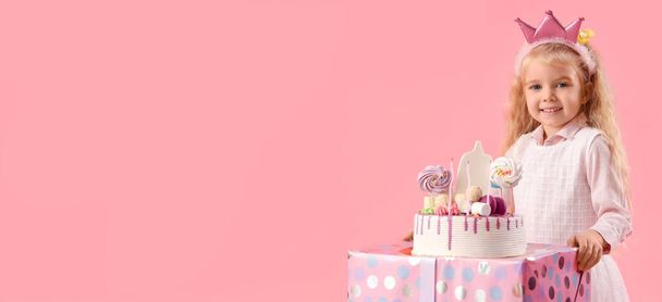 Cute little girl with Birthday cake and gift on pink background with space for text - Photo, Image