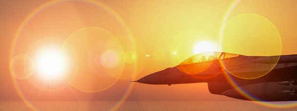 Solo fighter jet captured mid-flight with a dramatic sunset and intense lens flare. - Photo, Image