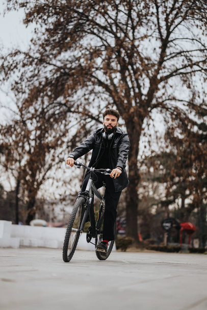Профессиональный предприниматель мужского бизнеса, путешествующий на велосипеде в парке, смешивающий фитнес с бизнесом. - Фото, изображение