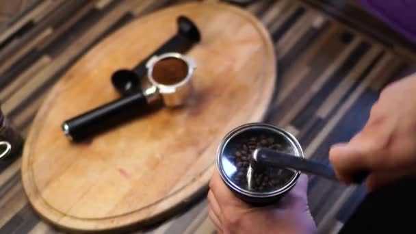 Barista macina chicchi di caffè su un macinino da caffè manuale ruotando la maniglia. Filmati 4k di alta qualità - Filmati, video