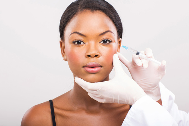 Cosmetic surgeon injecting woman face - Photo, image