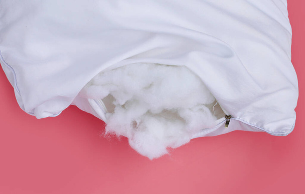 White pillow with polyester stable fiber on pink background. - Photo, Image