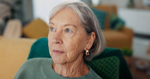 Face, thinking and senior woman on sofa with Alzheimer, memory loss and depression in nursing home. Old age, anxiety and elderly female with nostalgia, living room and mental health in retirement. - Photo, Image