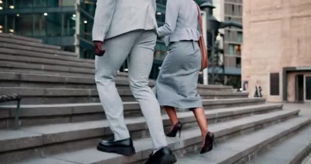 Business people, stairs and discussion with walking, travel and morning commute to office. Man, woman and corporate buildings in New York for conversation, communication or journey to work together. - Video